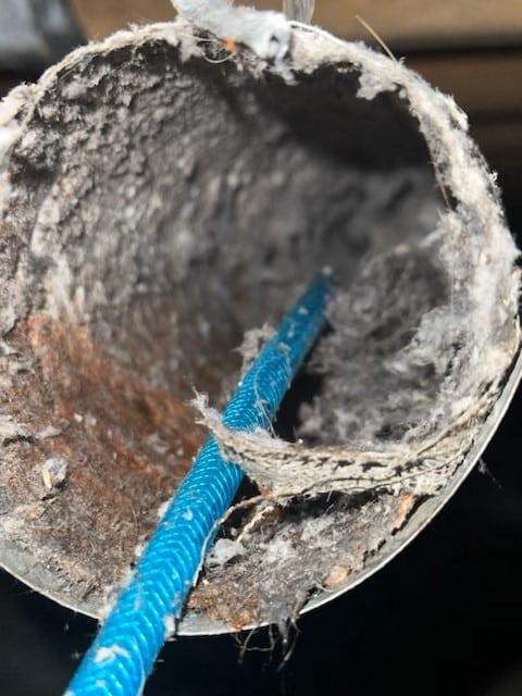 Severely clogged dryer vent filled with lint buildup
