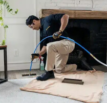 Technician cleaning an air duct