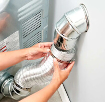 Dryer vent being cleaned