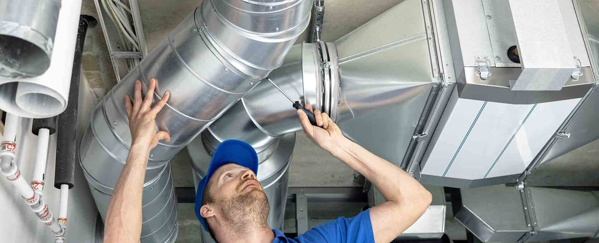 Air Duct Cleaning technician inspecting the furnace and air handler unit before starting the duct cleaning service.