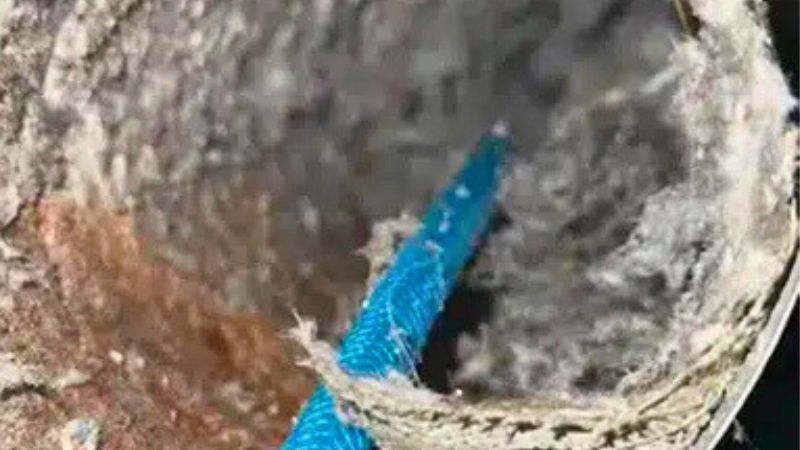 Technician cleaning a dryer vent duct during a Columbus home service appointment