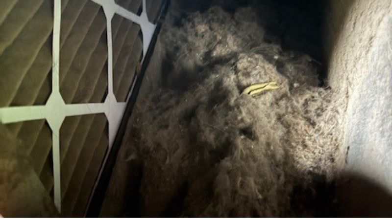 Extremely dirty air vent register covered in dust and debris compared to a clean, shiny register
